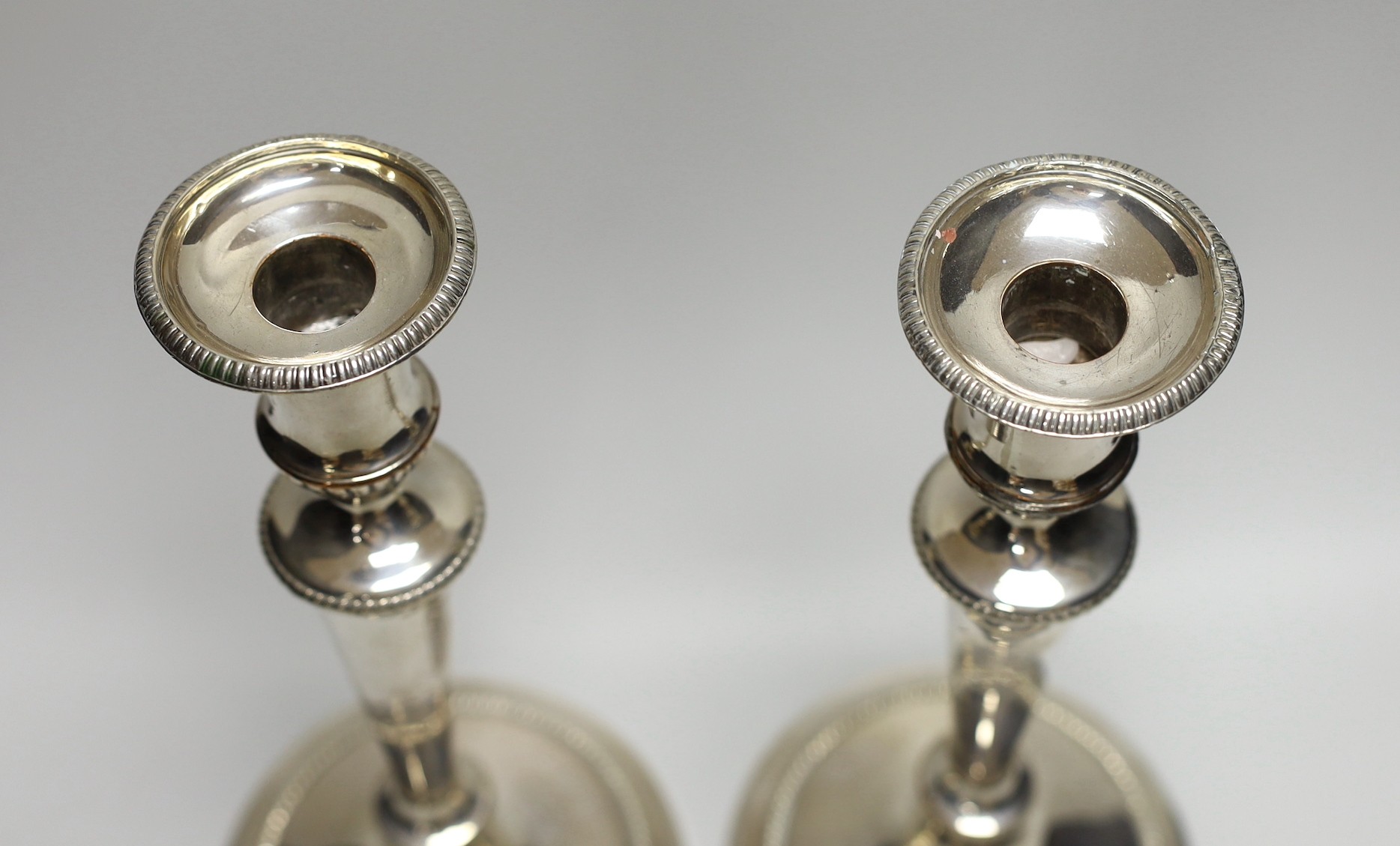 A pair of early 19th century Old Sheffield plate candlesticks. 28cm high